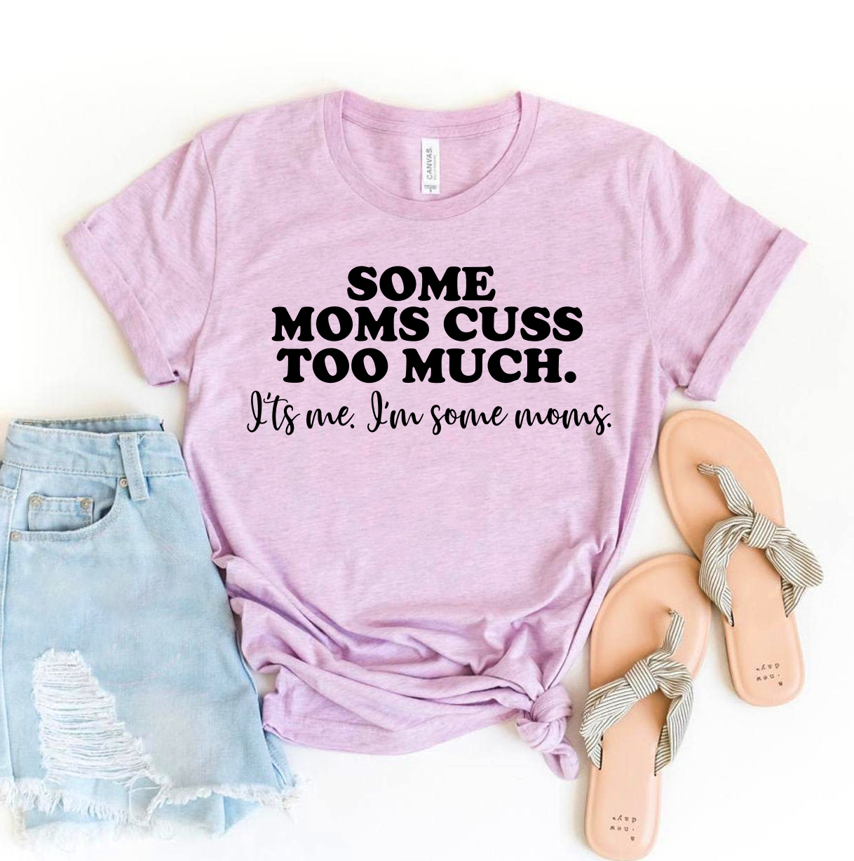 A stylish black t-shirt featuring the phrase 'Some Moms Cuss Too Much It's Me' in bold white lettering, made from soft ring spun cotton.