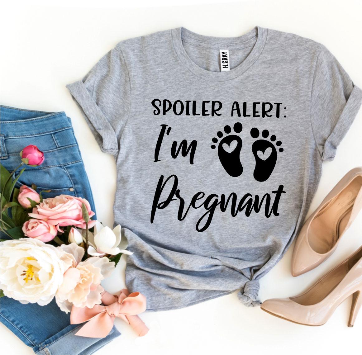 Spoiler Alert I’m Pregnant T-shirt in soft ring spun cotton, featuring a vibrant flex print design, available in various sizes.