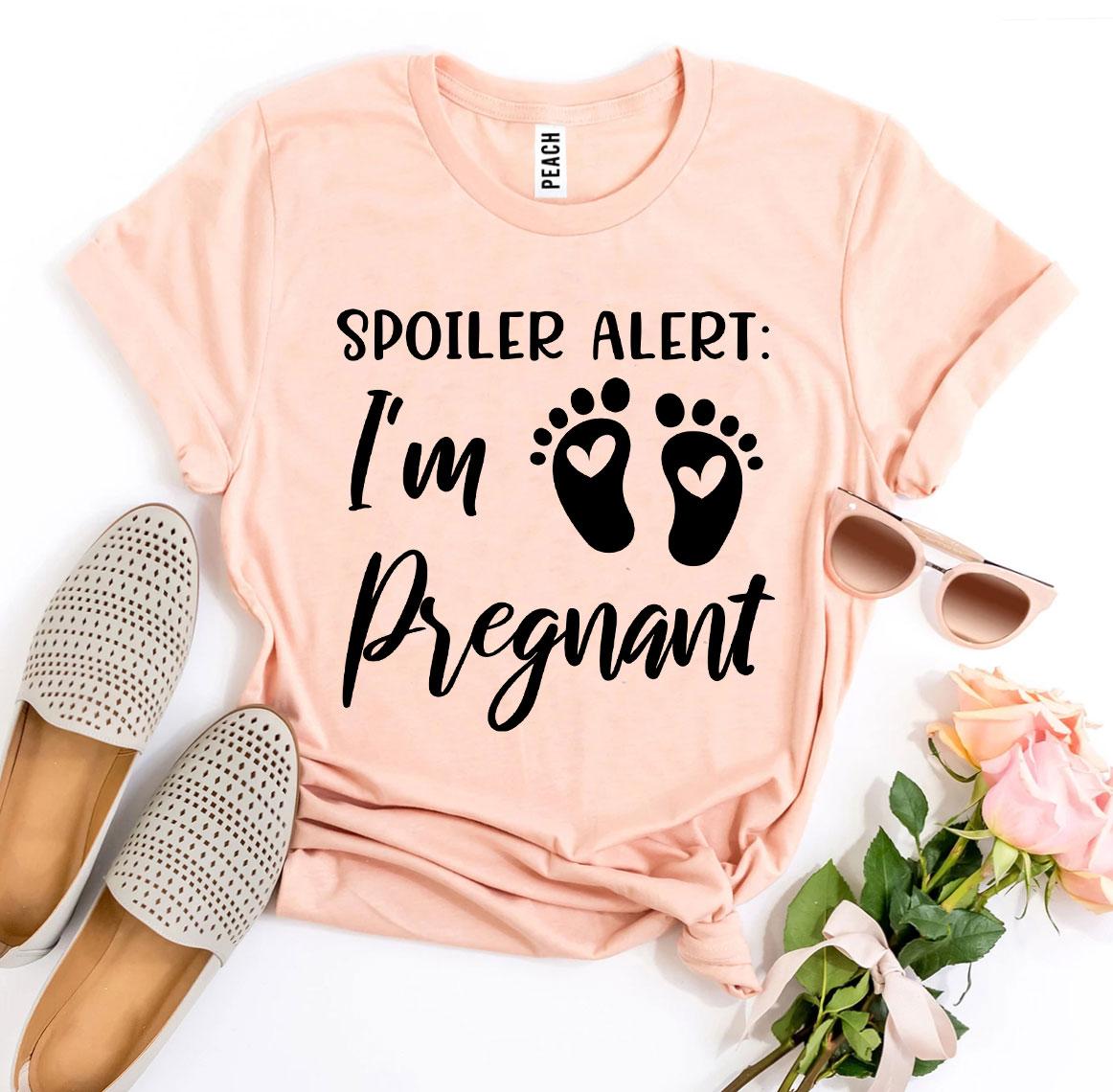 Spoiler Alert I’m Pregnant T-shirt in soft ring spun cotton, featuring a vibrant flex print design, available in various sizes.