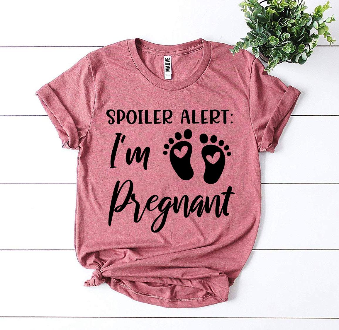 Spoiler Alert I’m Pregnant T-shirt in soft ring spun cotton, featuring a vibrant flex print design, available in various sizes.