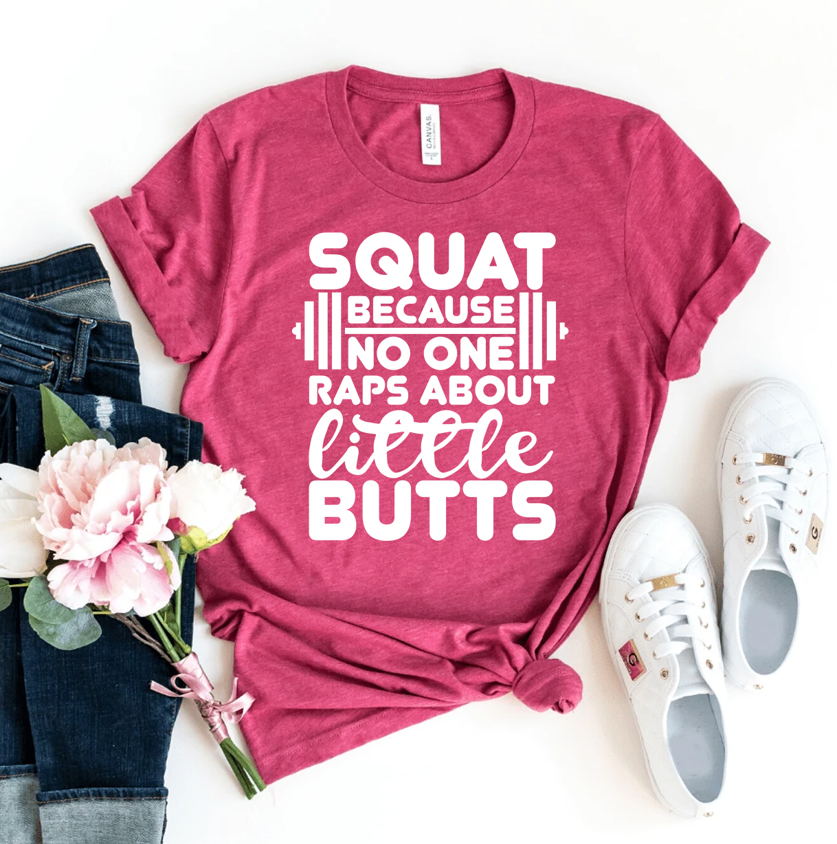 A humorous t-shirt featuring the slogan 'Squat Because No One Raps About Little Butts', made from soft ring spun cotton.