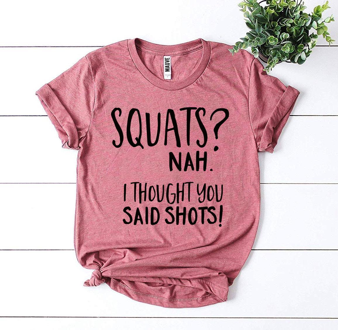 A humorous t-shirt featuring the slogan 'Squats? Nah’ I Thought You Said Shots!' made from premium ring spun cotton.