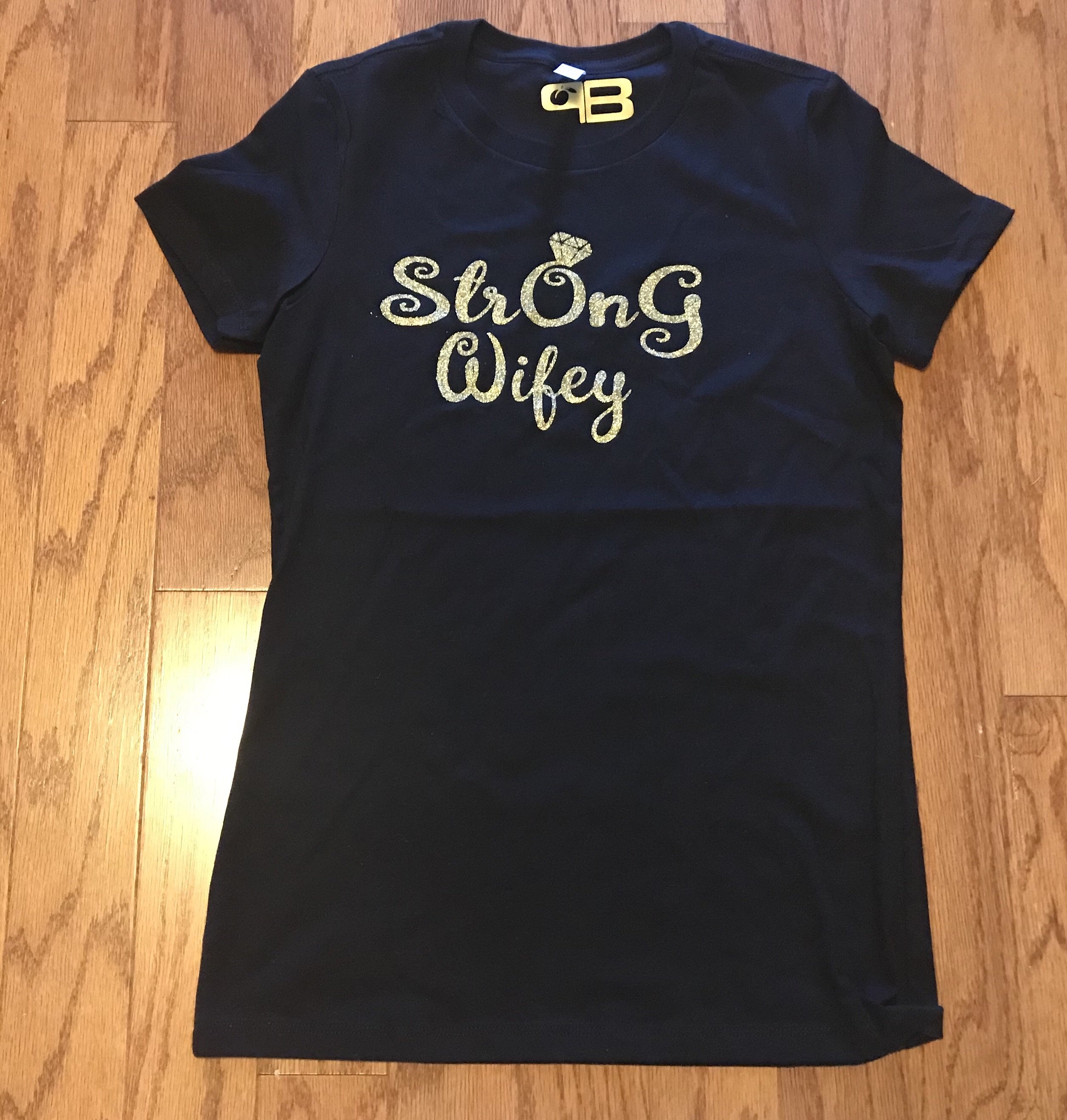 A soft and comfortable StrOnG Wifey Shirt featuring the empowering message 'Strength On God' in stylish lettering.