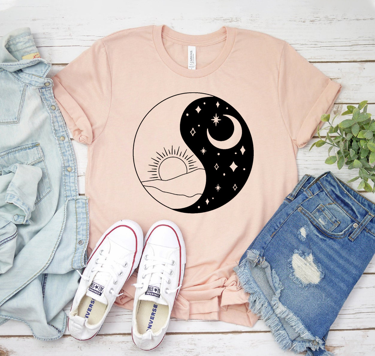 A stylish Sun & Moon T-shirt featuring a unique graphic design, made from soft airlume cotton, available in various sizes.