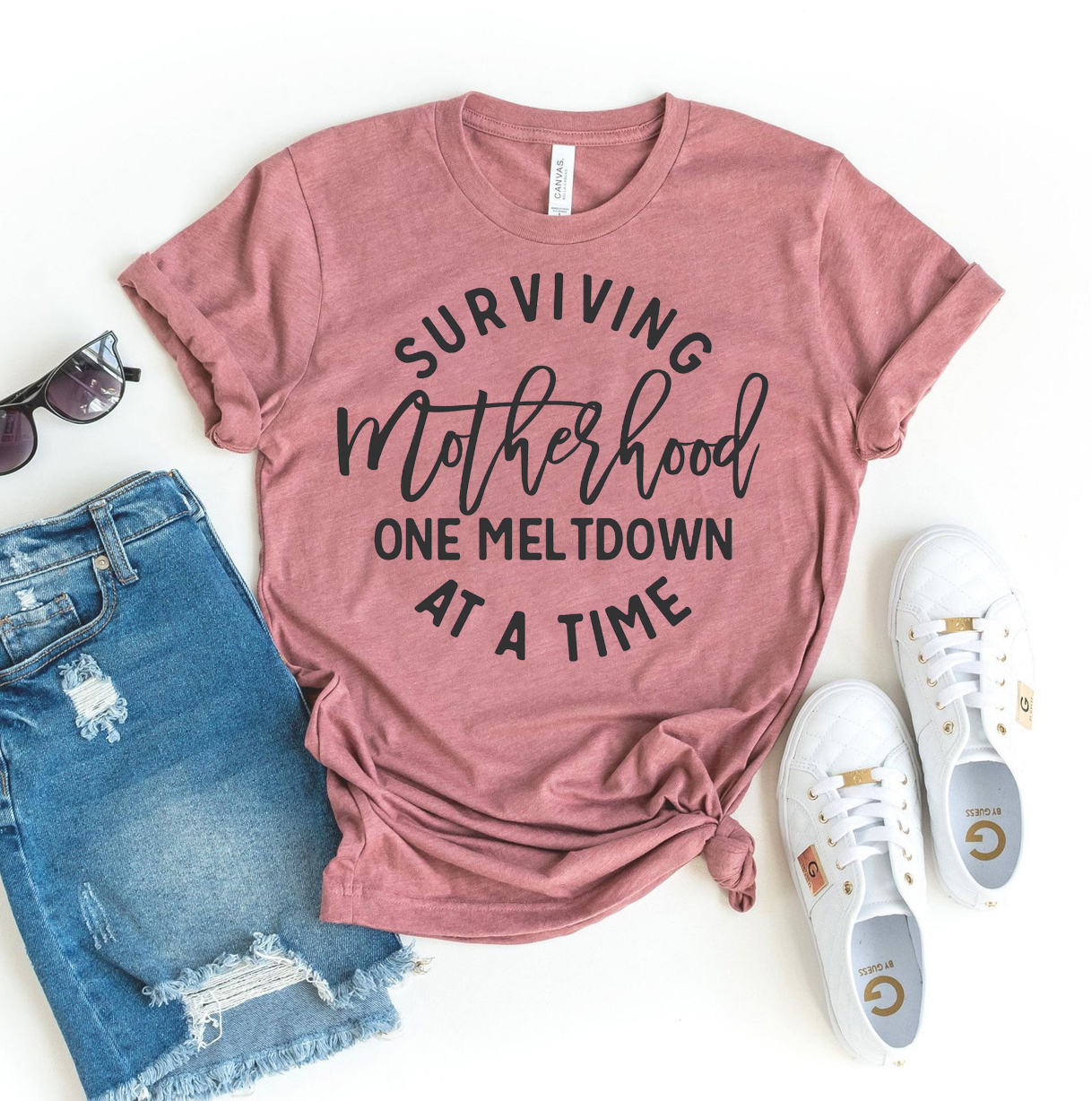 Surviving Motherhood One Meltdown At A Time T-shirt in various sizes, showcasing premium ring spun cotton and vibrant flex print design.