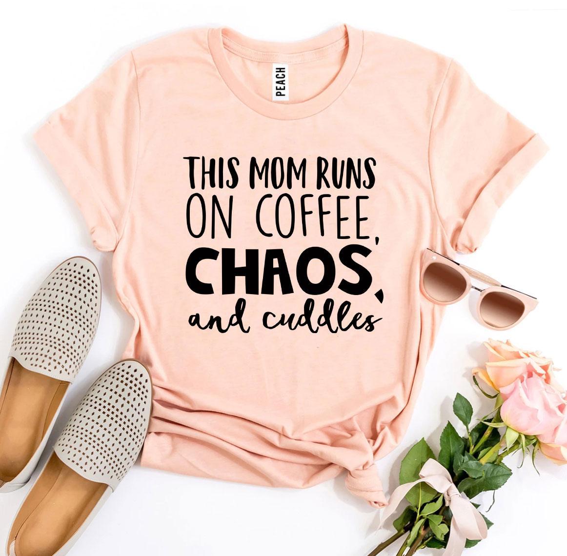 A stylish t-shirt featuring the phrase 'This Mom Runs On Coffee, Chaos, & Cuddles' printed on premium quality cotton fabric.