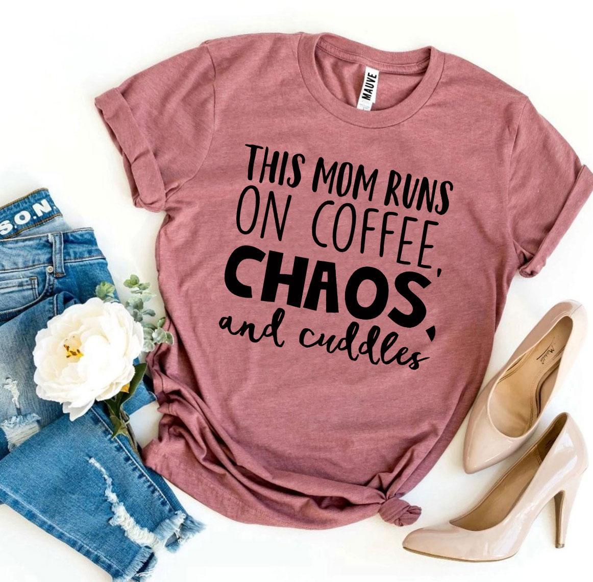 A stylish t-shirt featuring the phrase 'This Mom Runs On Coffee, Chaos, & Cuddles' printed on premium quality cotton fabric.