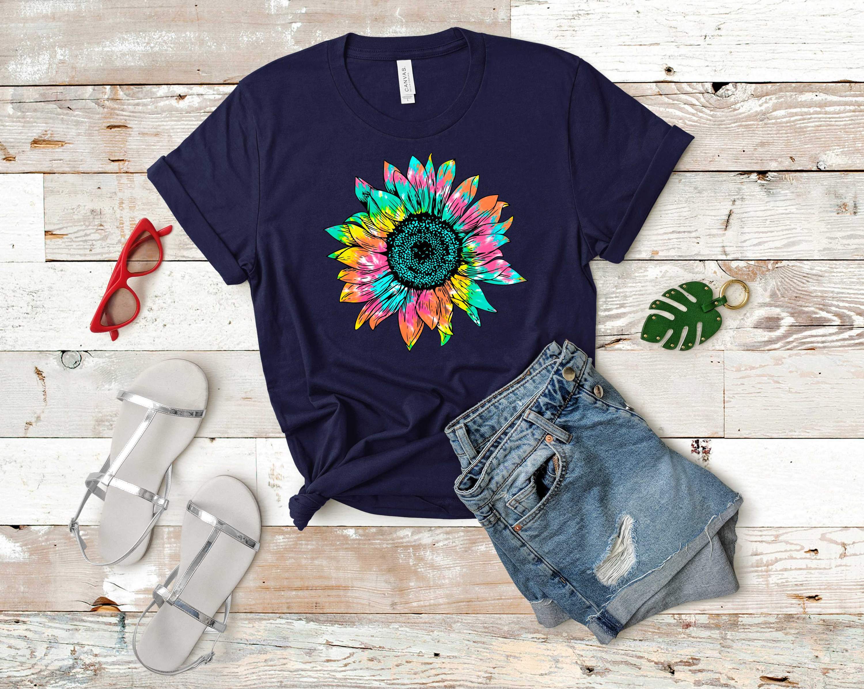 A vibrant tie dye graphic tee featuring a sunflower design, showcasing a colorful blend of hues.