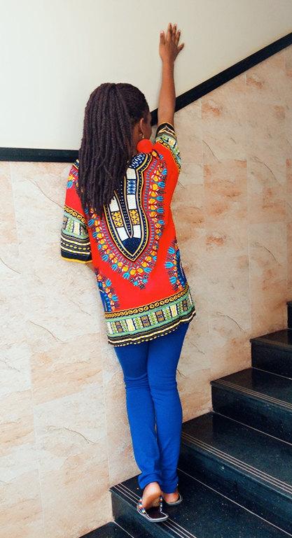 Traditional Dashiki African Shirt made of 100% cotton with vibrant print, showcasing front and back design.