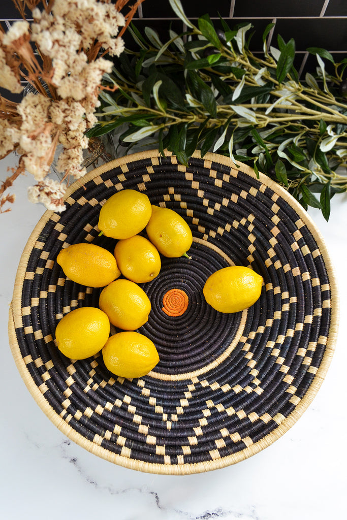 Handcrafted Uganda sisal wall and storage basket made from natural fibers, showcasing intricate weaving patterns and earthy tones.