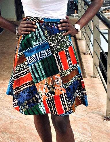 A vibrant Vintage Batik Wrap Mini Kitenge Skirt featuring unique handmade patterns and adjustable straps, perfect for various occasions.