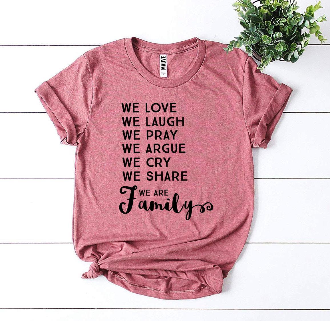 We Love We Laugh We Are Family T-shirt in various sizes, showcasing its soft cotton fabric and vibrant print design.