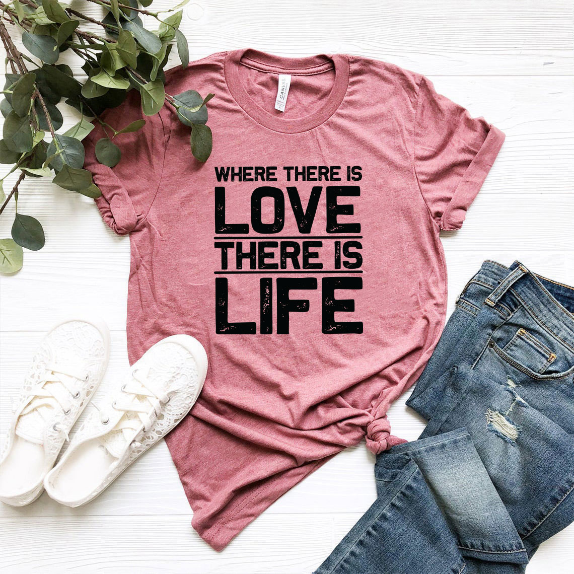 Unisex T-shirt featuring the quote 'Where There Is Love There Is Life' in vibrant colors, made from soft ring spun cotton.