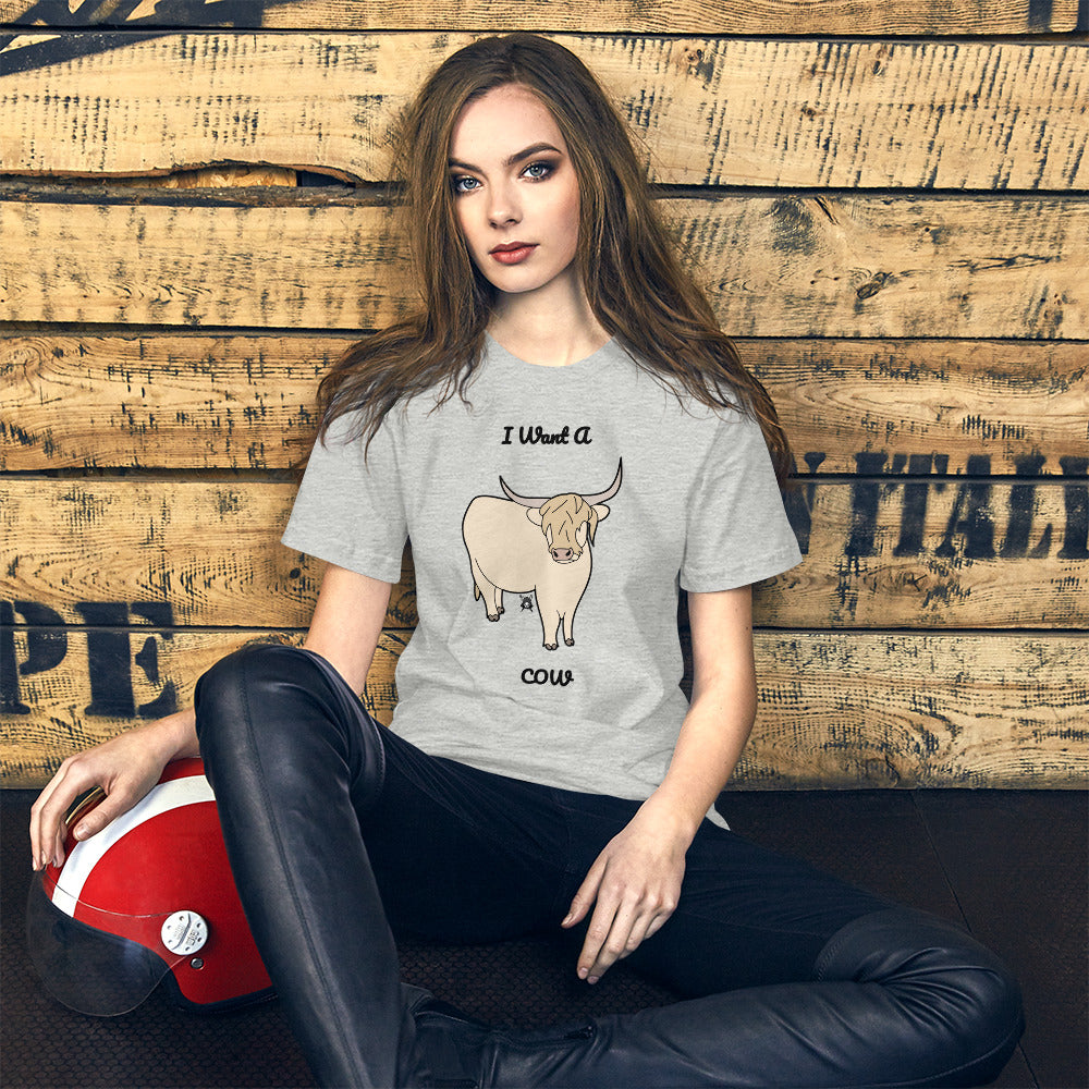 A stylish white t-shirt featuring the phrase 'I Want A Cow' printed in a fun font, perfect for cow lovers.