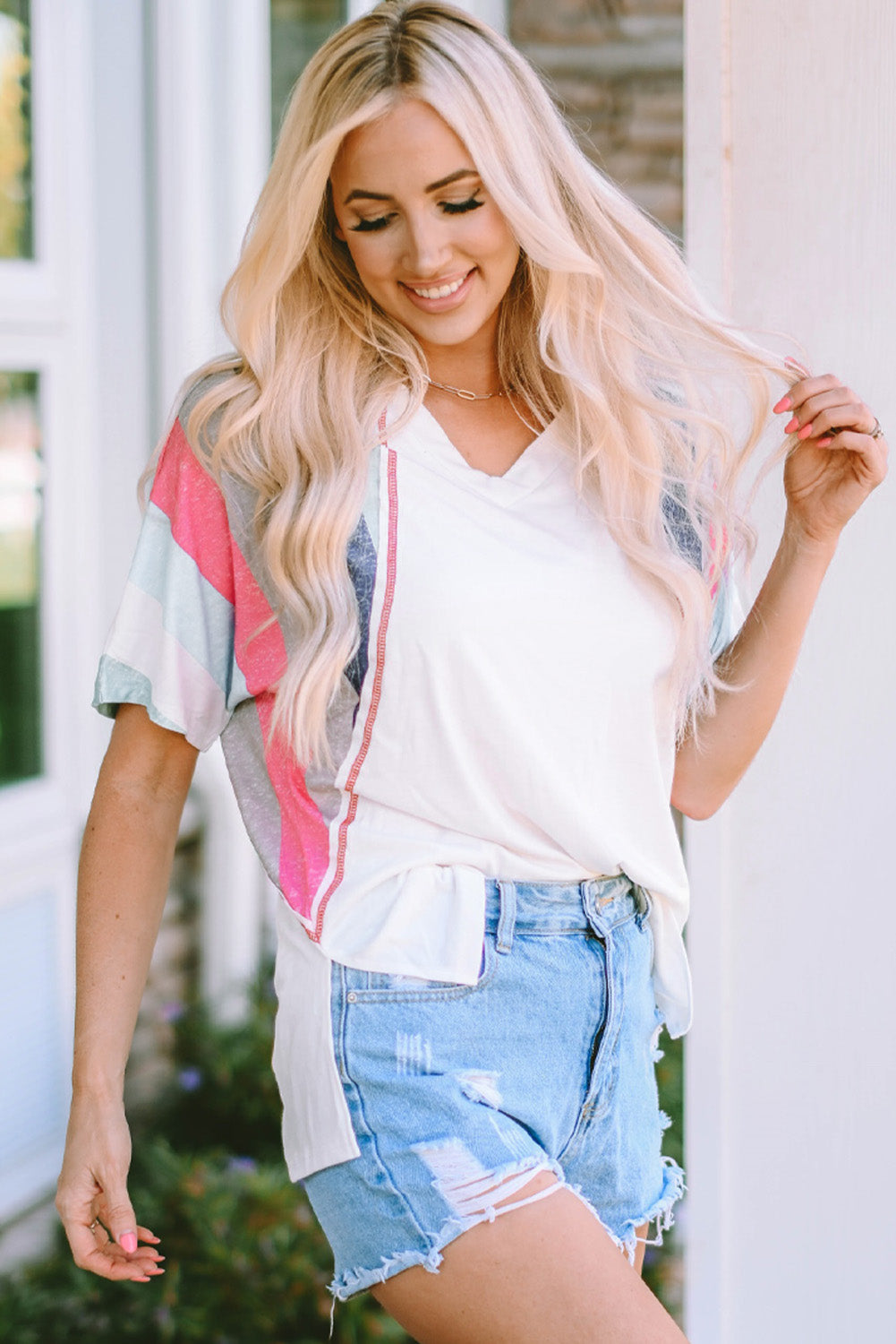 White Stripe Patchwork T Shirt featuring colorful horizontal stripes and a v-neckline, designed for comfort and style.