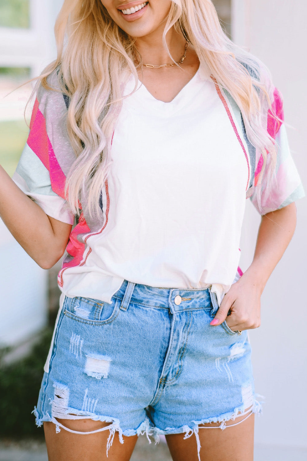 White Stripe Patchwork T Shirt featuring colorful horizontal stripes and a v-neckline, designed for comfort and style.