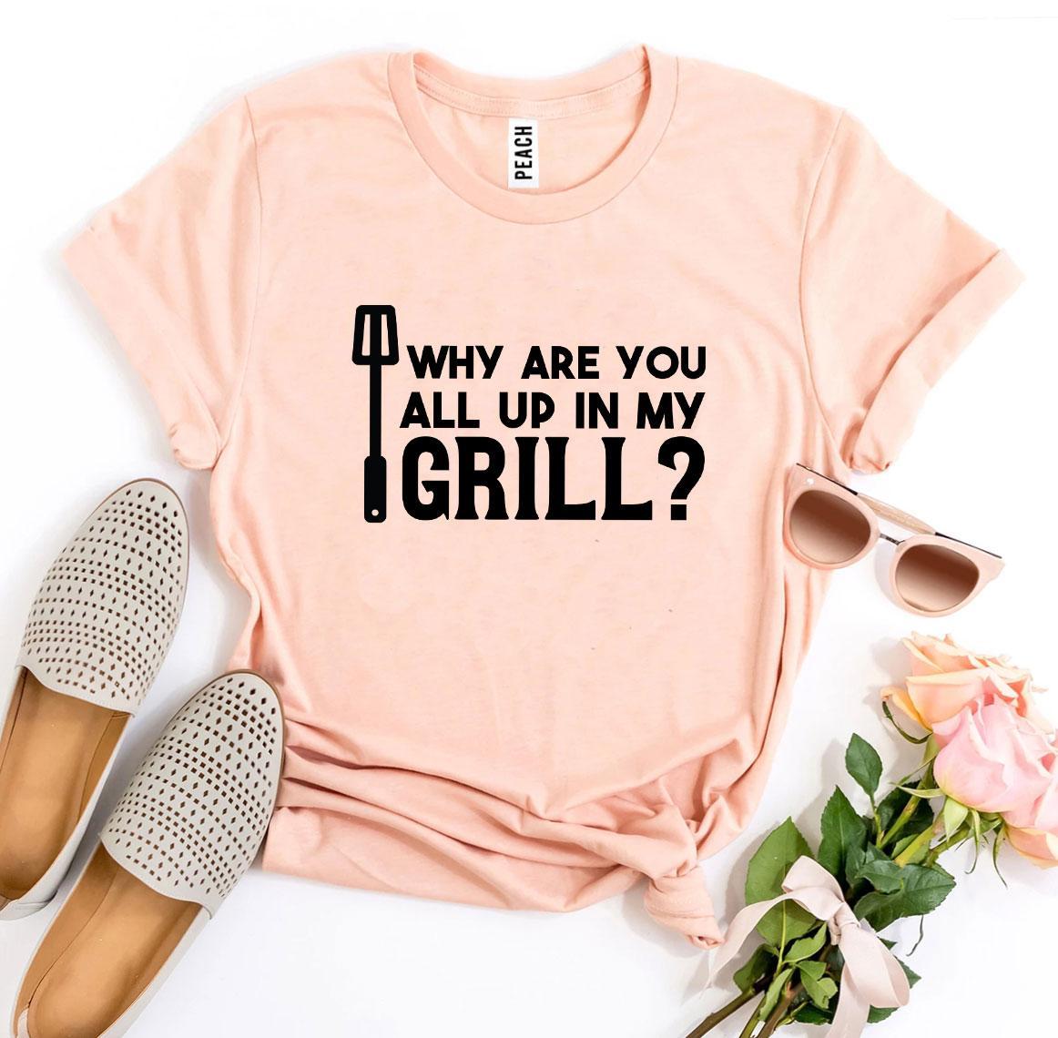 A stylish black t-shirt featuring the humorous slogan 'Why Are You All Up In My Grill?' printed in bold letters, made from soft ring spun cotton.