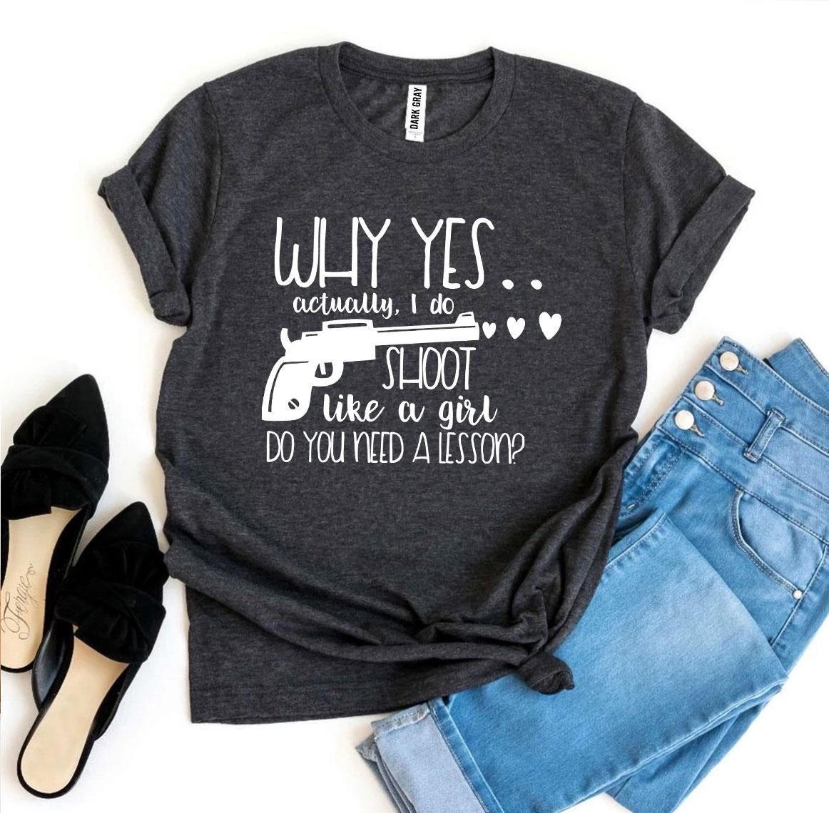 A stylish black t-shirt featuring the phrase 'Why Yes Actually I Do Shoot Like a Girl' in bold print, made from premium quality cotton.