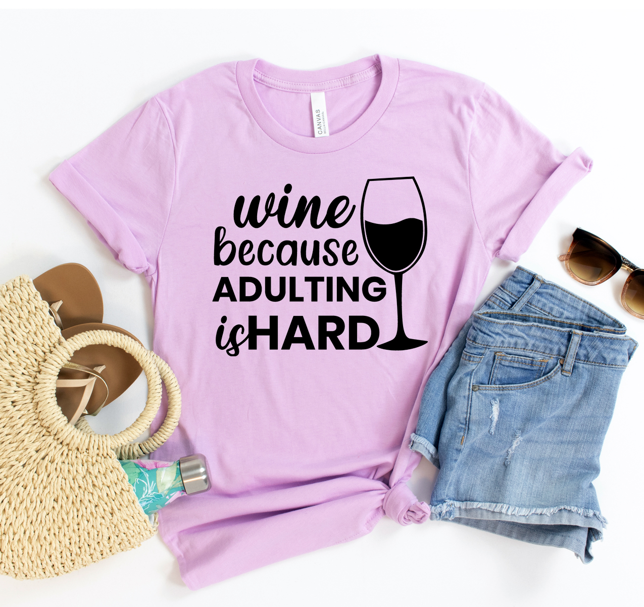 A stylish unisex t-shirt featuring the phrase 'Wine Because Adulting Is Hard' in a fun font, made from soft cotton fabric.