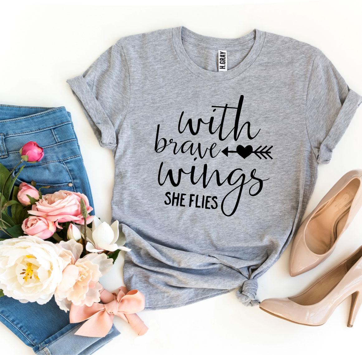 A stylish 'With Brave Wings She Flies' T-shirt made from premium ring spun cotton, featuring a vibrant flex print design.