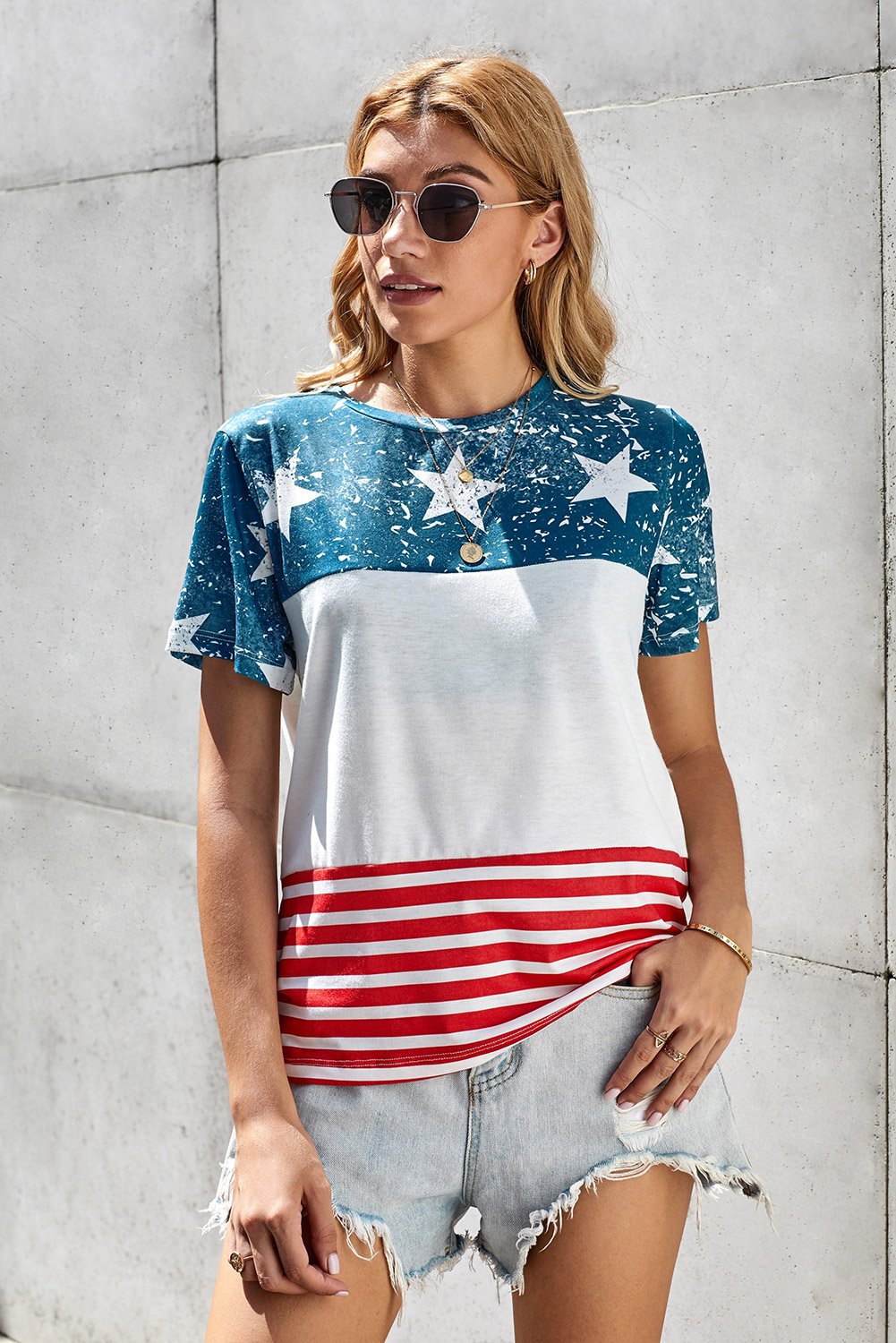 Women’s short sleeve tee featuring an American flag print, perfect for summer casual wear.