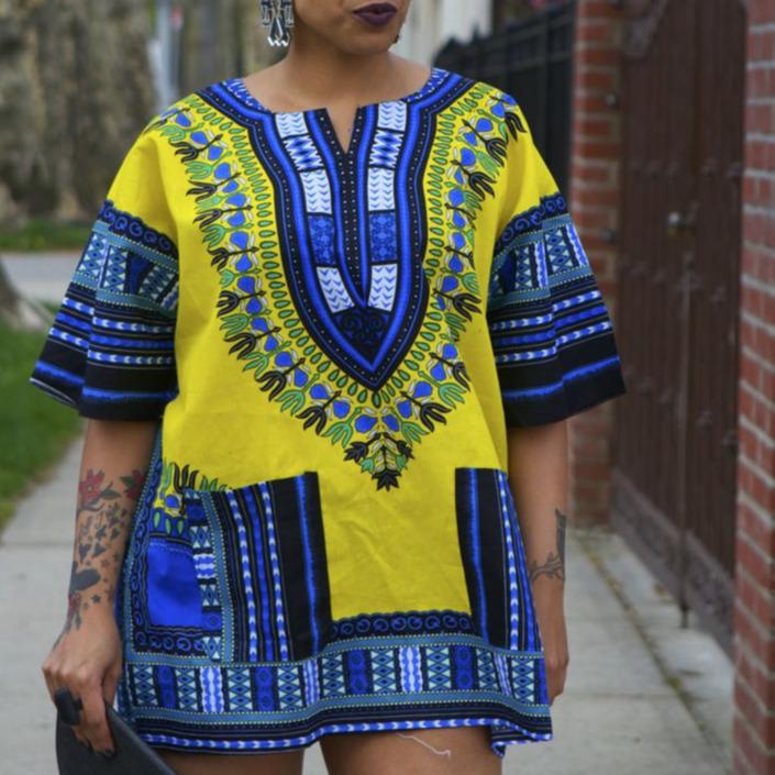 A vibrant yellow Dashiki shirt made from 100% cotton, showcasing a reversible design suitable for festive occasions.