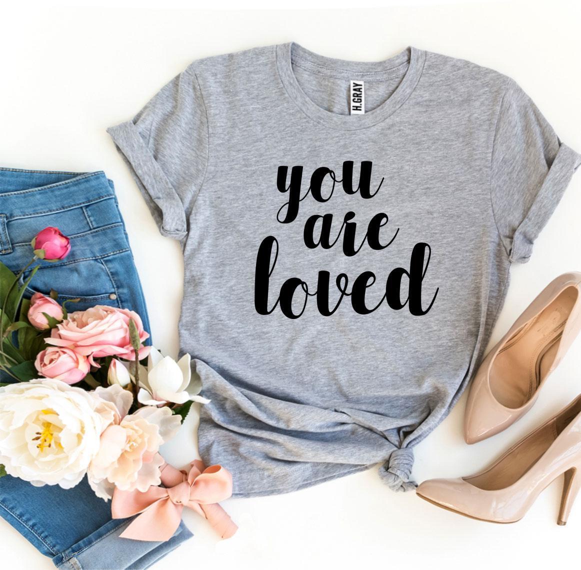 You Are Loved T-shirt made of premium ring spun cotton with a soft feel and vibrant print, available in various sizes.