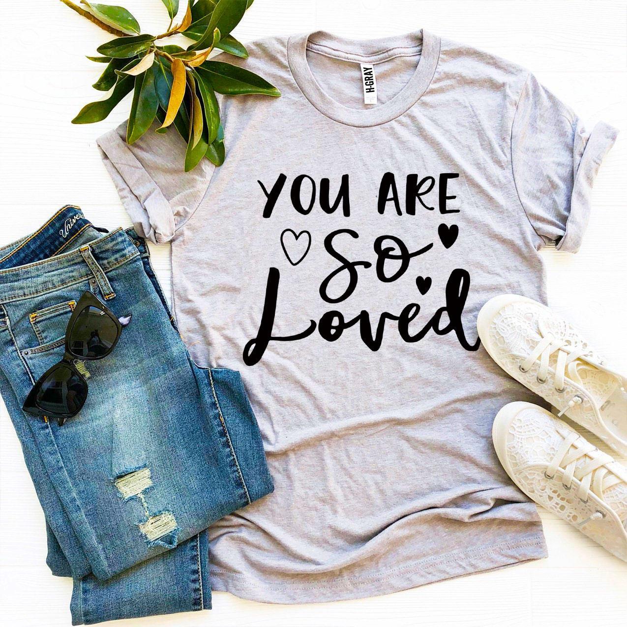 You Are So Loved T-shirt in various sizes, showcasing its soft fabric and vibrant print.