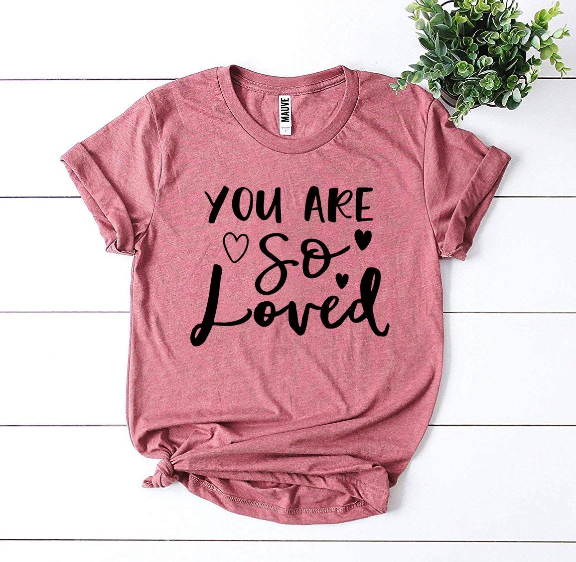 You Are So Loved T-shirt in various sizes, showcasing its soft fabric and vibrant print.