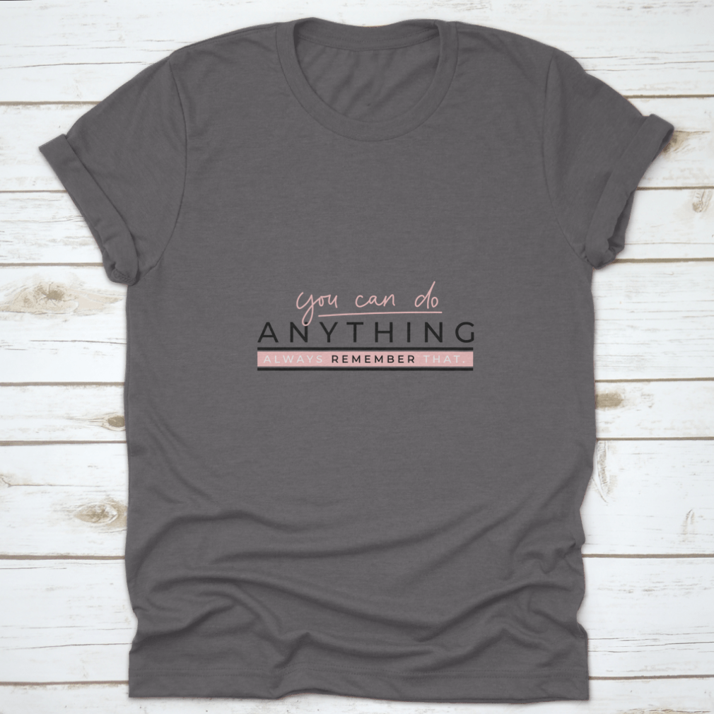 A motivational T-shirt featuring the quote 'You Can Do Anything' in stylish blush pink lettering on a soft cotton fabric.