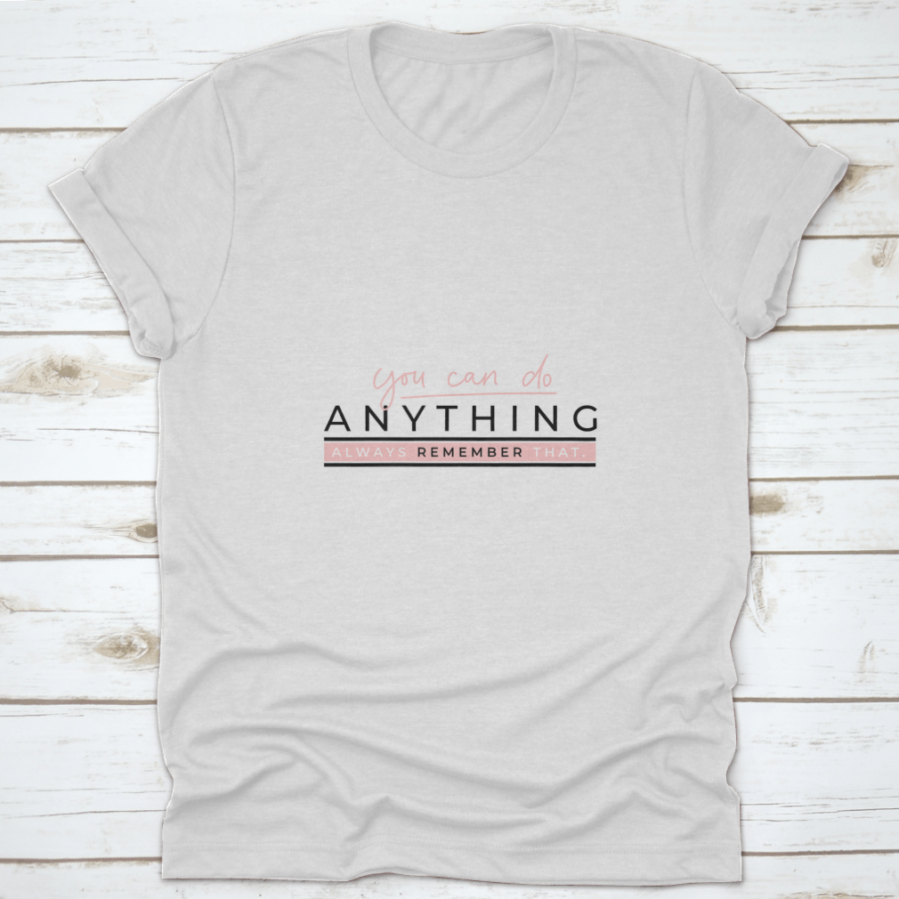 A motivational T-shirt featuring the quote 'You Can Do Anything' in stylish blush pink lettering on a soft cotton fabric.