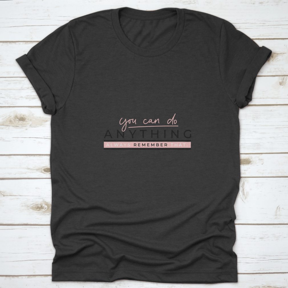 A motivational T-shirt featuring the quote 'You Can Do Anything' in stylish blush pink lettering on a soft cotton fabric.