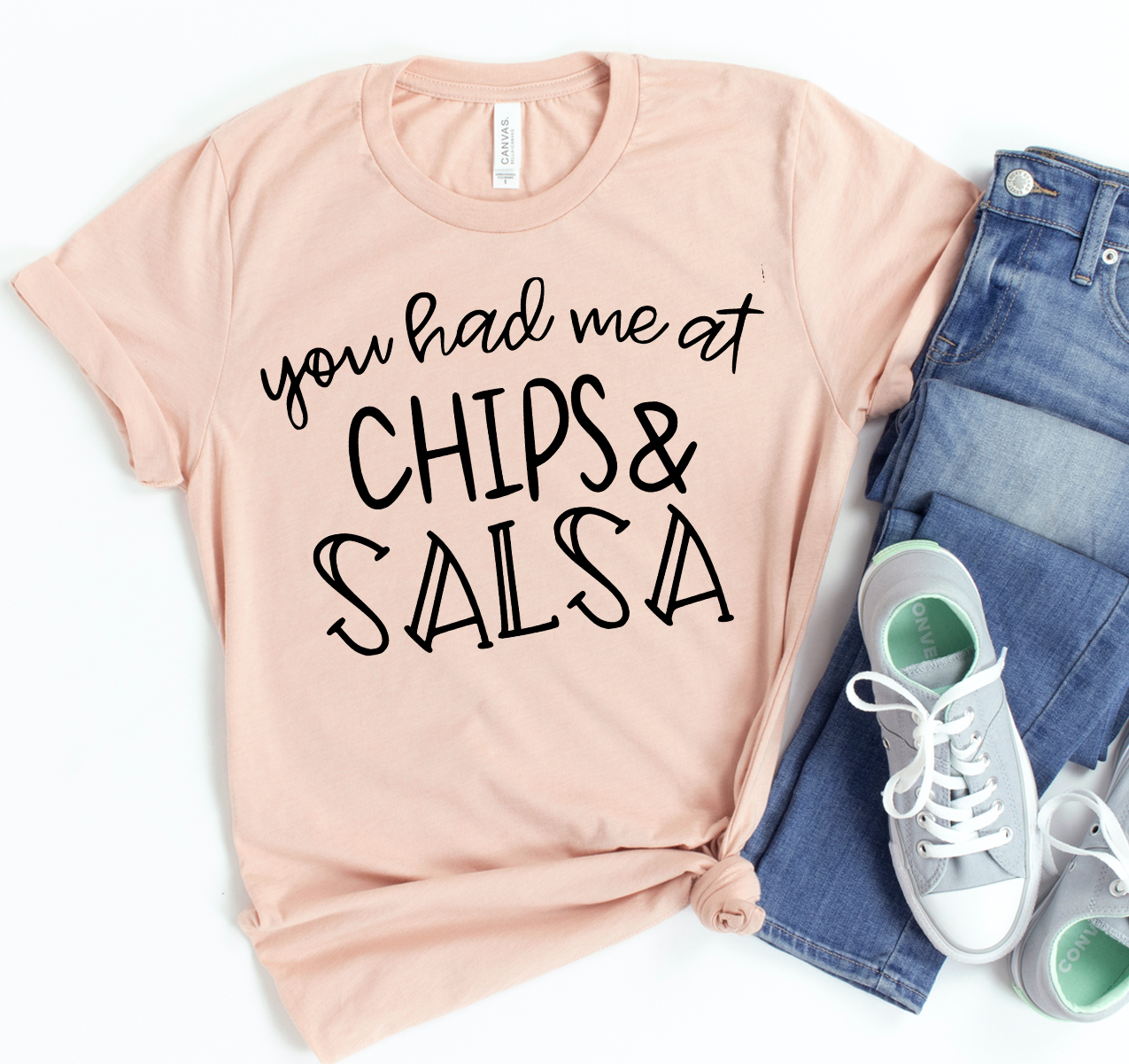 You Had Me At Chips & Salsa T-shirt displayed on a hanger, showcasing its vibrant design and soft fabric.