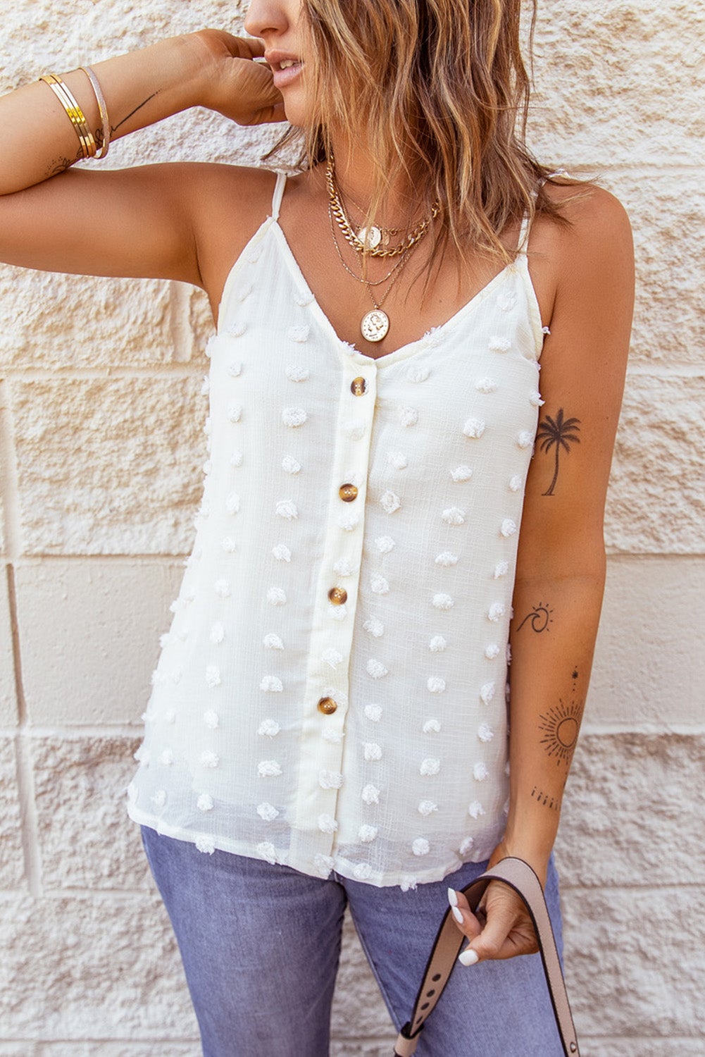 Beige Swiss Dot Tank top featuring adjustable spaghetti straps and button closure, perfect for summer wear.