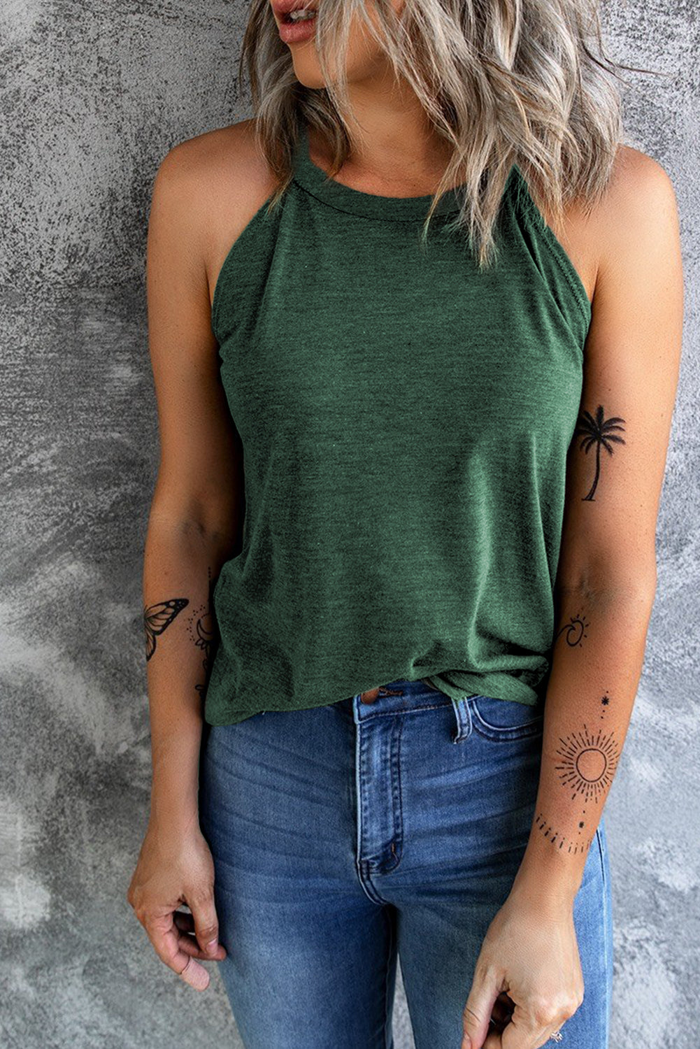 A stylish Brief Green Crew Neck Tank Top displayed on a mannequin, showcasing its sleeveless design and soft fabric.