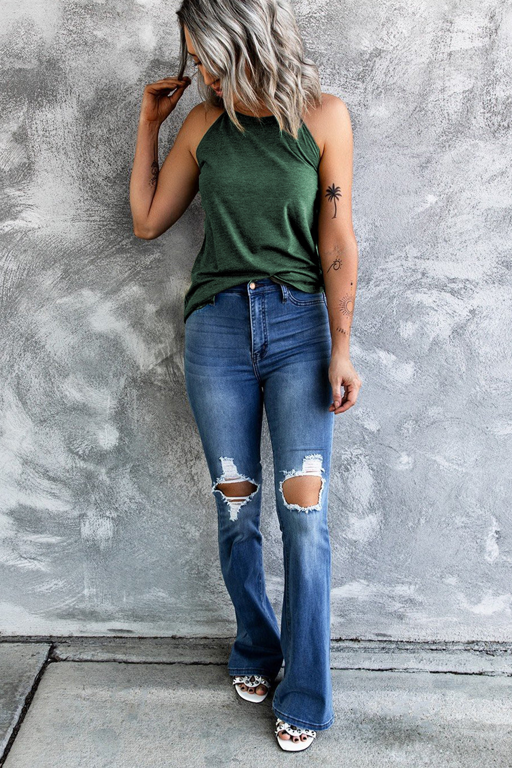 A stylish Brief Green Crew Neck Tank Top displayed on a mannequin, showcasing its sleeveless design and soft fabric.