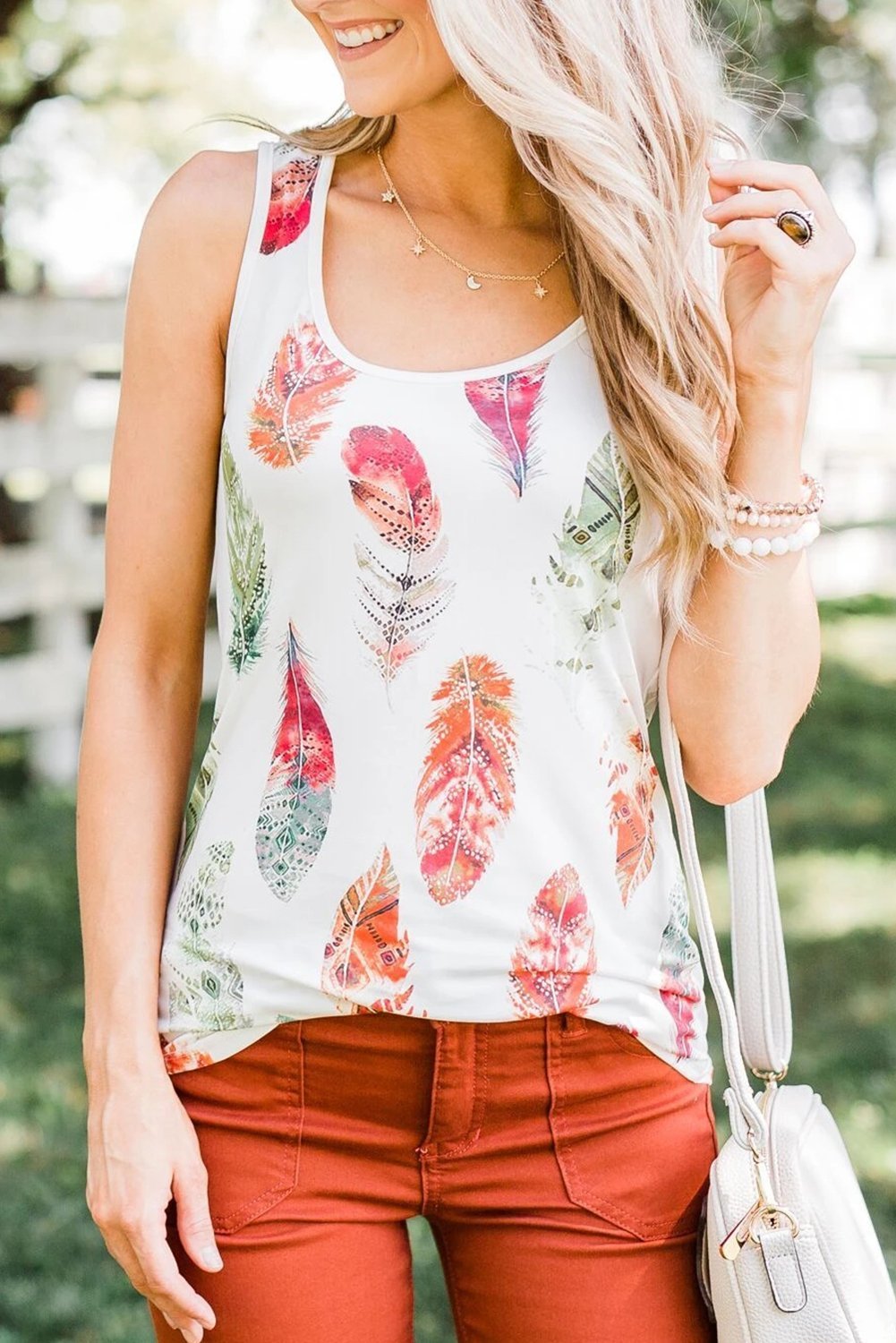 Cute multicolor Aztec feather summer tank top displayed on a mannequin, showcasing its vibrant design and bra-friendly fit.