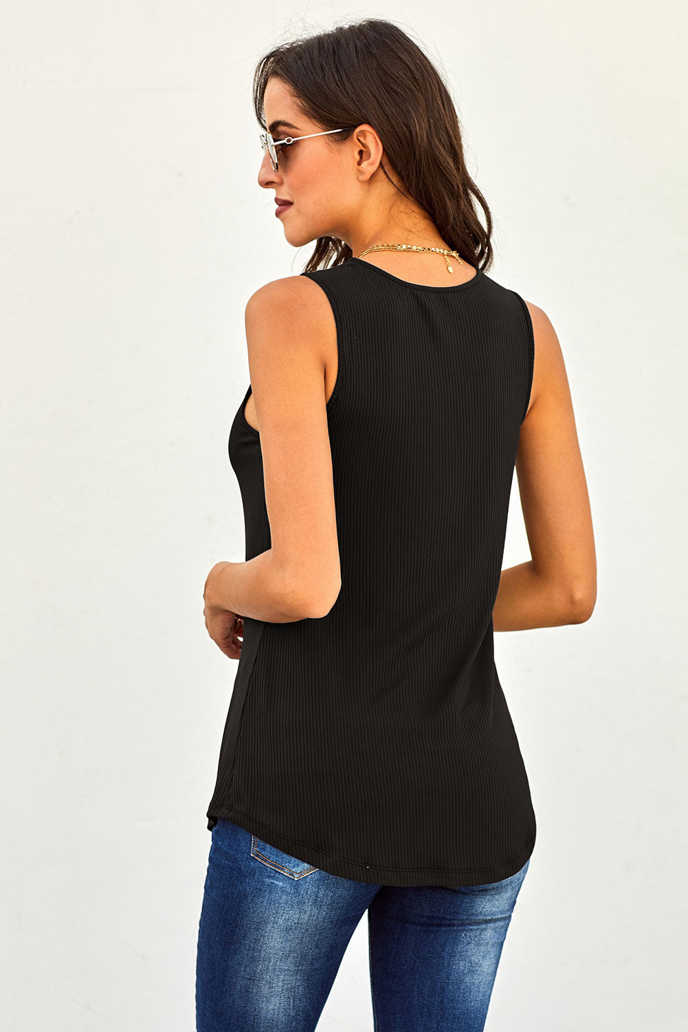 A stylish black tank top featuring a ribbed texture and a decorative 3-button detail, perfect for summer layering.