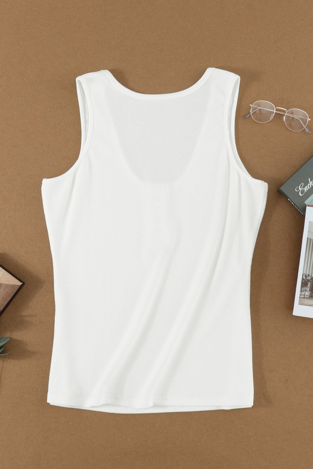 Women's white sleeveless scoop neck tank top with button placket detail, perfect for summer wear.