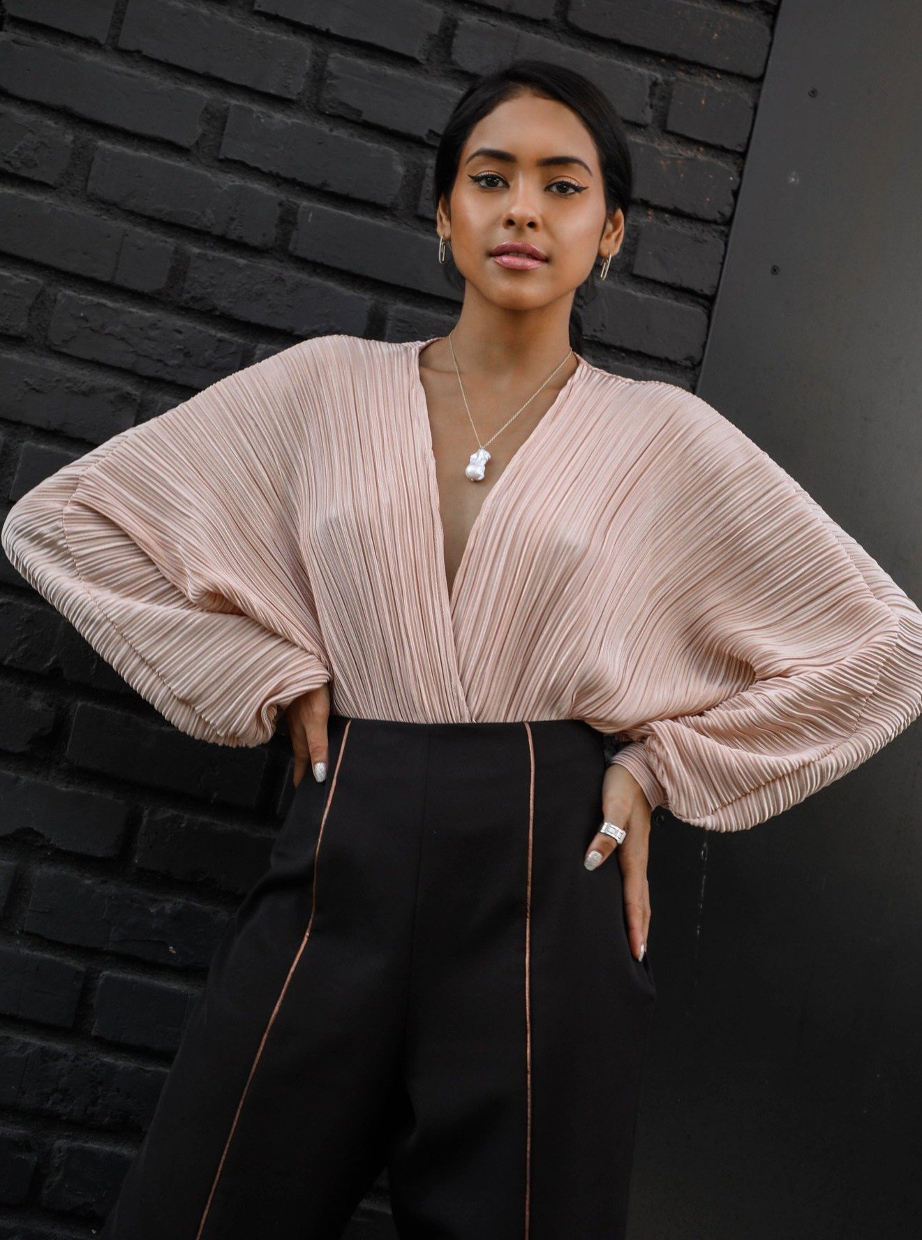 Amora Wrap Bodysuit featuring a plunging neckline, soft pleats, and dramatic blouson sleeves in a lustrous hue.