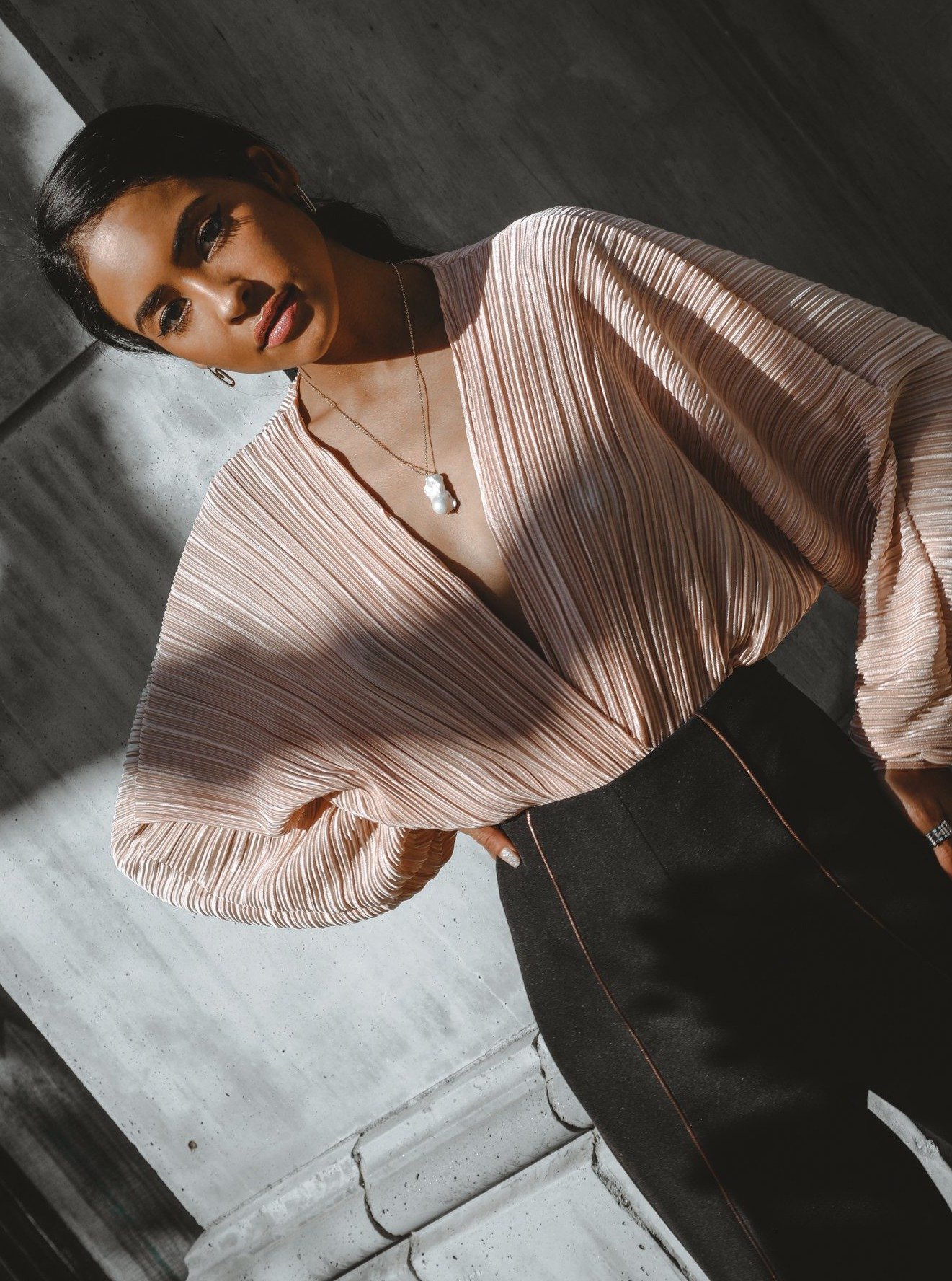 Amora Wrap Bodysuit featuring a plunging neckline, soft pleats, and dramatic blouson sleeves in a lustrous hue.