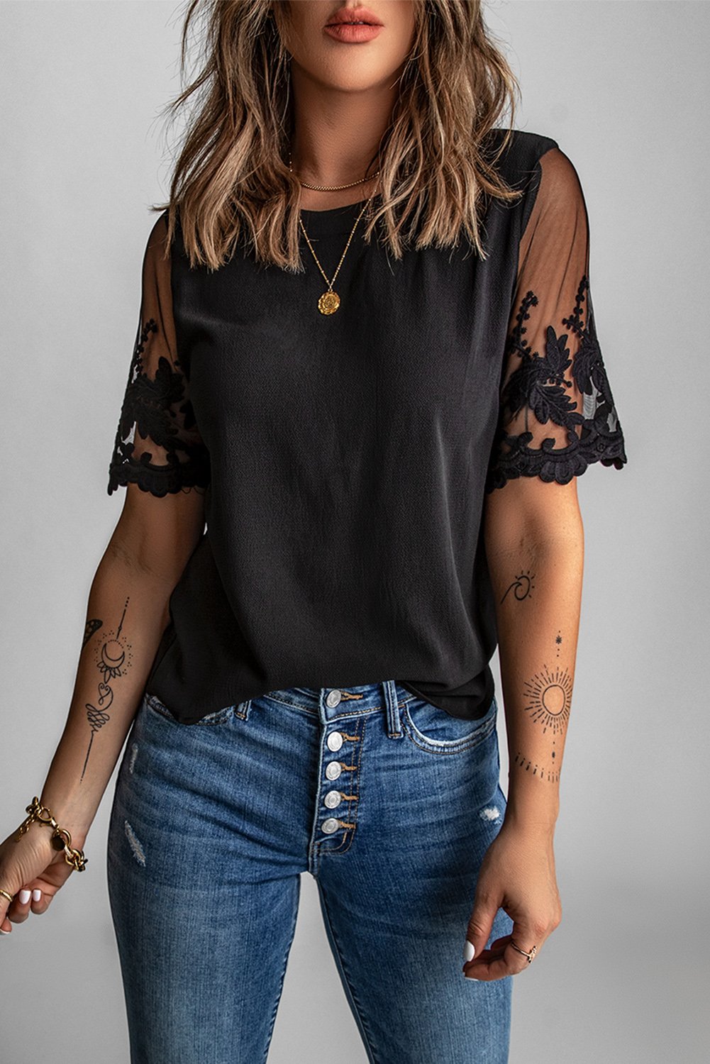 A stylish black lace short sleeve top featuring sheer floral mesh sleeves and a round neckline, perfect for summer wear.