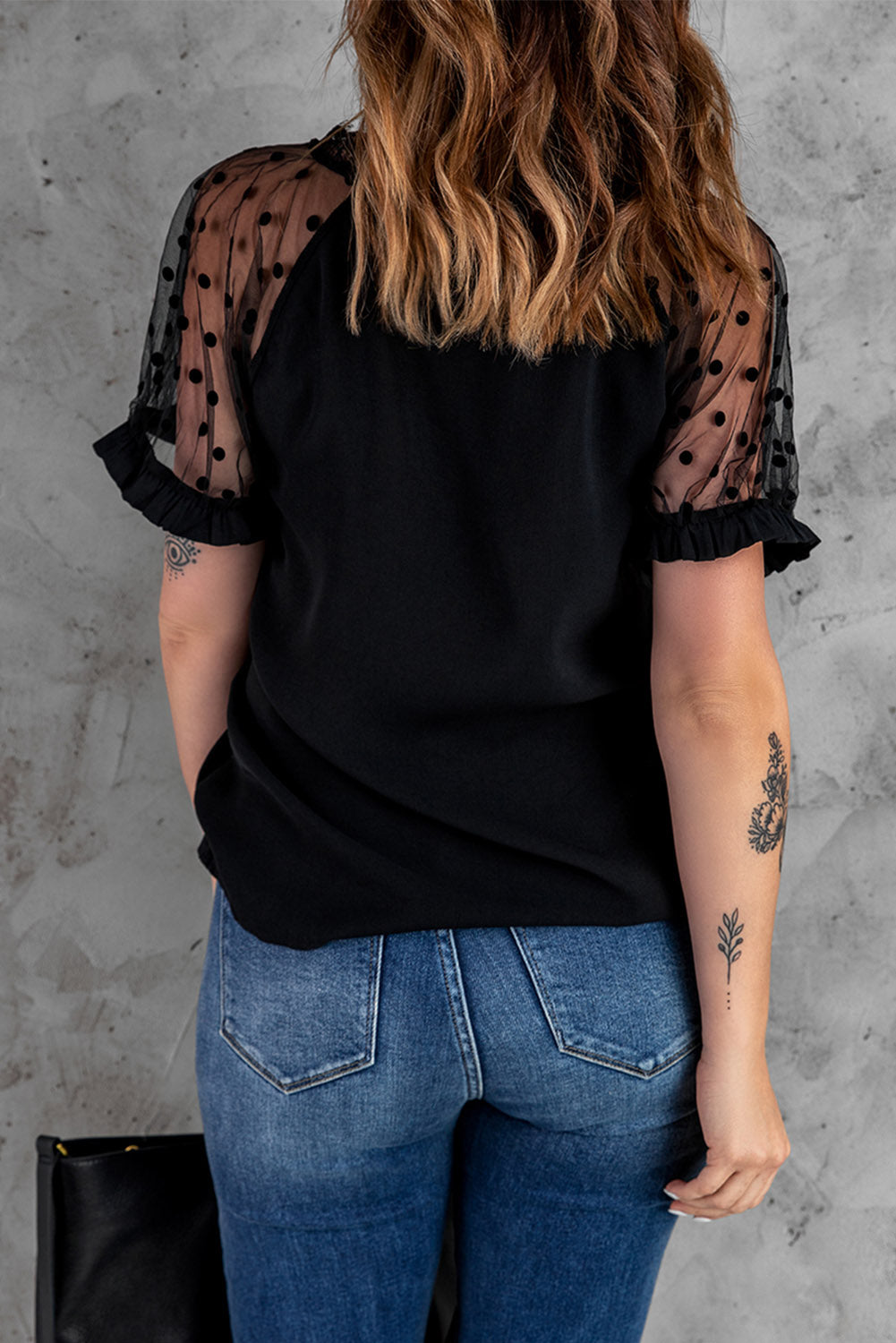 Black short sleeve blouse with polka dot print and lace neckline, perfect for summer fashion.