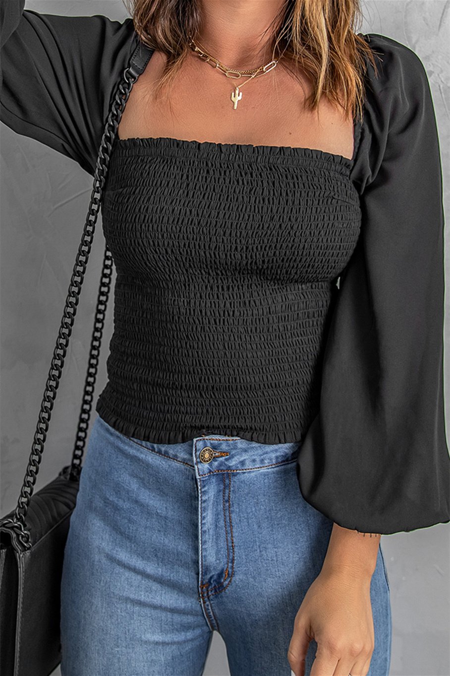 Black Puff Sleeve Smocked Top featuring a square neckline and elegant puff sleeves, perfect for casual wear.