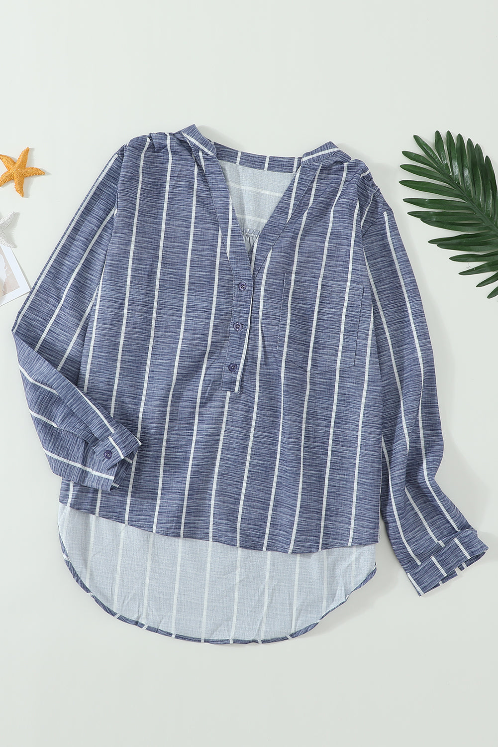 Blue striped button-down blouse with v-neckline and full sleeves, featuring a bust pocket and button cuffs.