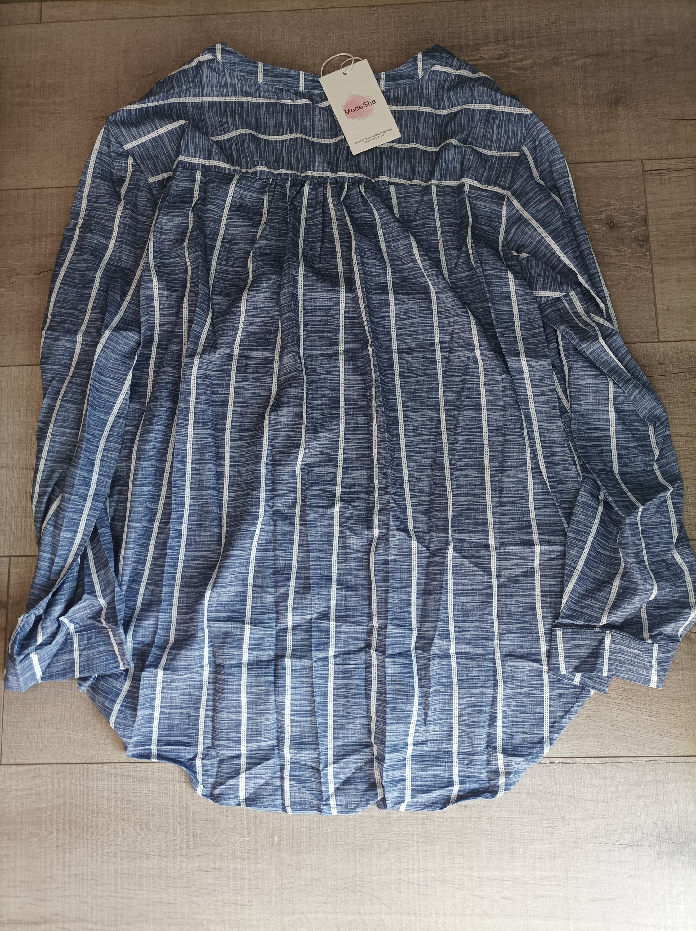 Blue striped button-down blouse with v-neckline and full sleeves, featuring a bust pocket and button cuffs.