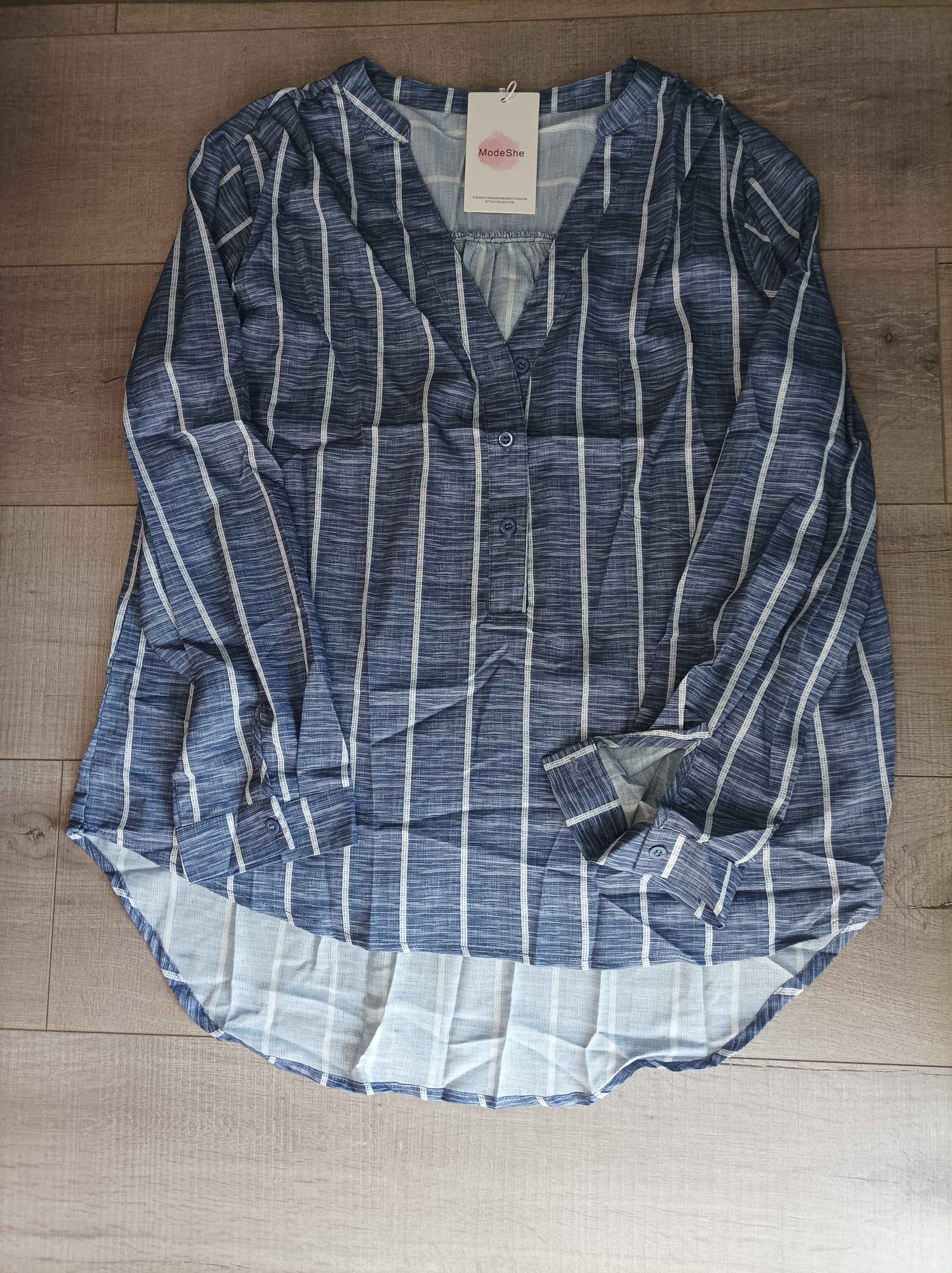 Blue striped button-down blouse with v-neckline and full sleeves, featuring a bust pocket and button cuffs.