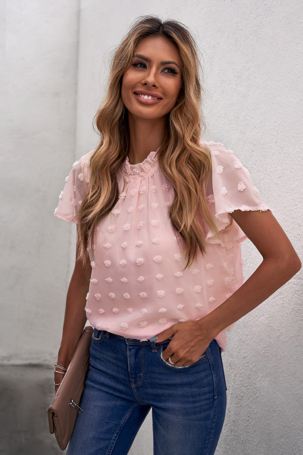 Blush pink blouse with ruffled sleeves and swiss dot fabric, perfect for summer styling.