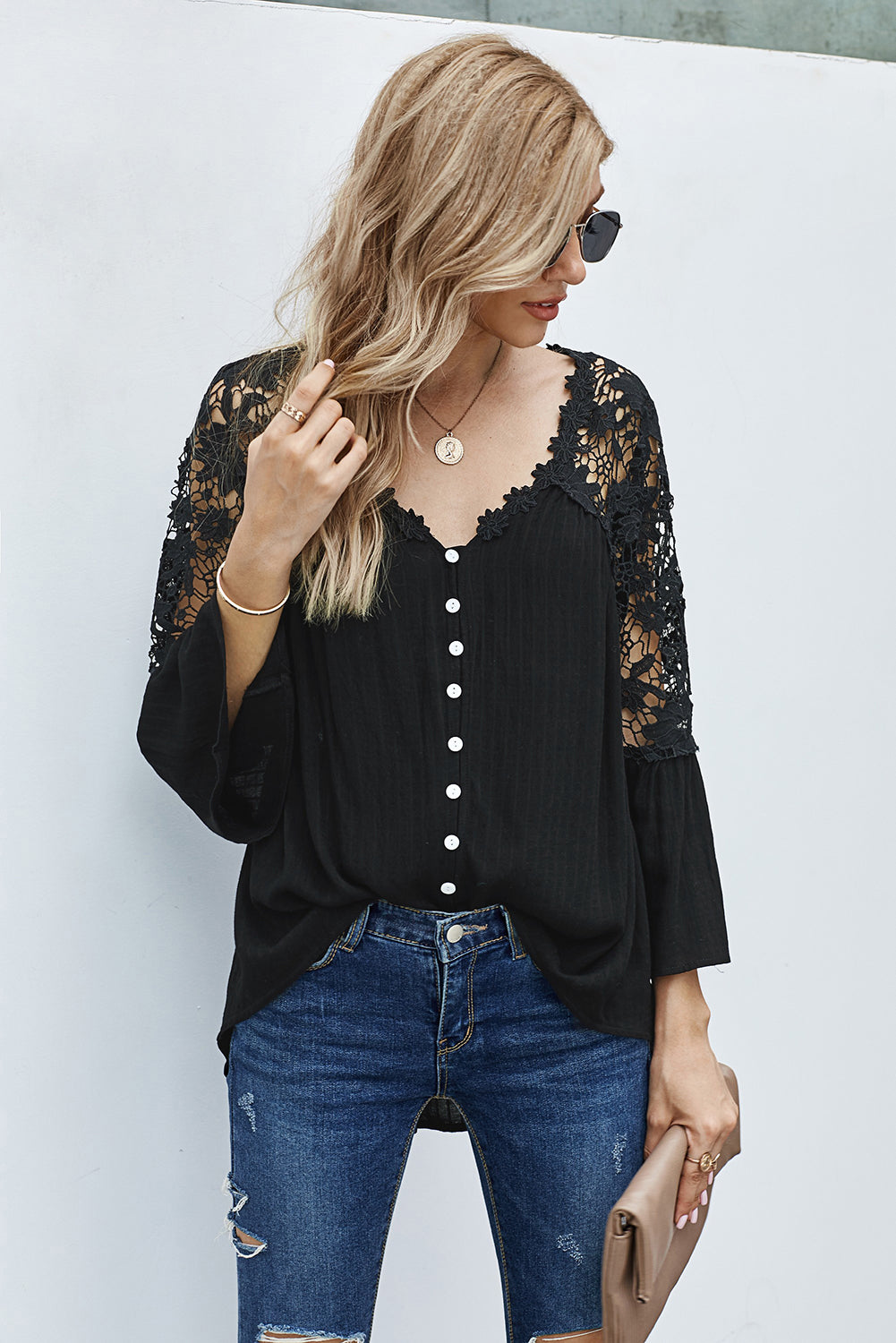 Elegant black crochet lace blouse with button front and three-quarter sleeves, perfect for casual and formal occasions.