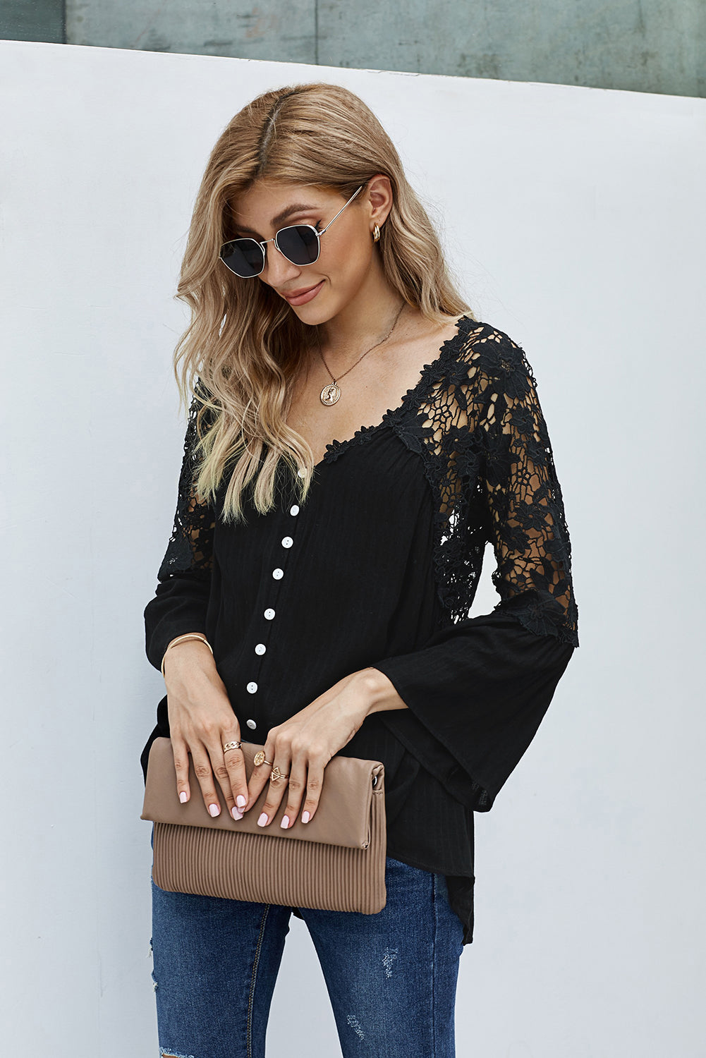 Elegant black crochet lace blouse with button front and three-quarter sleeves, perfect for casual and formal occasions.